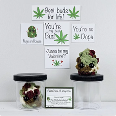 Two small jars with crocheted marijuana leaf characters, cards, and a certificate on a white background.